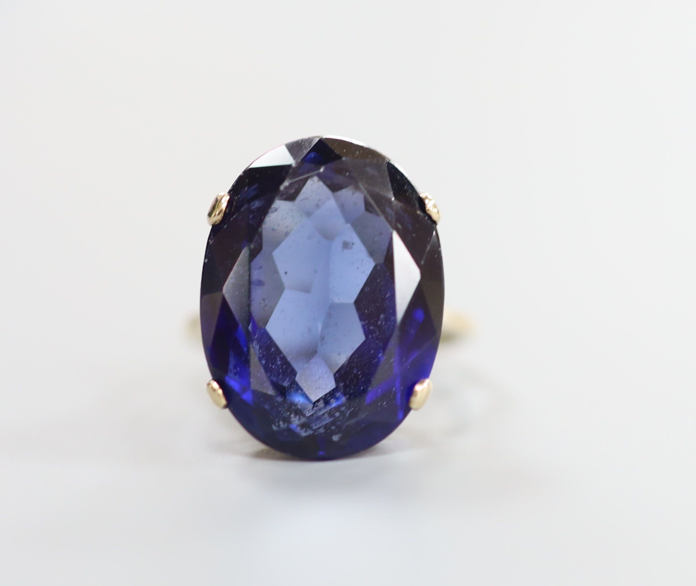 A 9ct gold and oval cut synthetic sapphire set dress ring, size L/M, gross 7.6 grams.